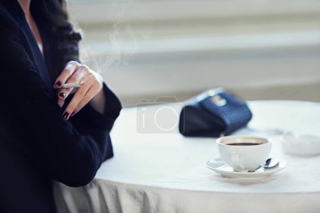 Photo for Woman, hands and smoking with coffee at cafe for morning tobacco, caffeine or nicotine. Closeup of female person or smoker with cigarette, cappuccino or americano at vintage or retro restaurant. - Royalty Free Image