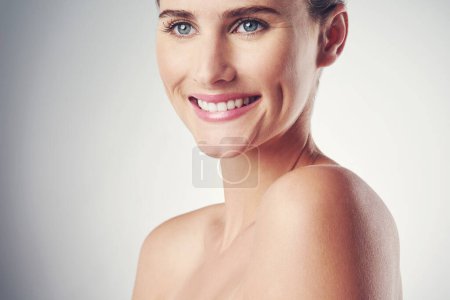 Photo for Woman, skincare and happy in studio for beauty with soft, smooth and clear skin with wellness. Girl, isolated and white background for cosmetics or dermatology, self care and confidence with mockup. - Royalty Free Image