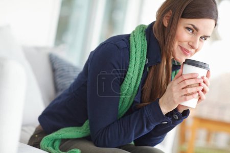 Téléchargez les photos : Woman, portrait and happy with coffee in house for morning routine in winter to warm up and relax for cozy ambiance. Girl, caffeine beverage and indoor bliss in home for contentment and chilling - en image libre de droit