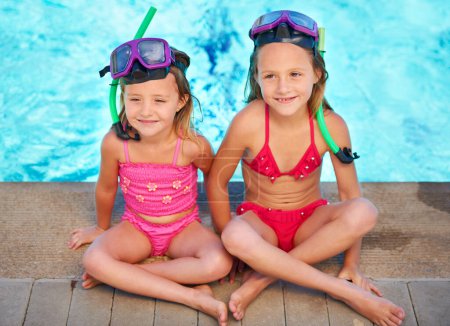 Photo for Kids, sitting and relax at swimming pool in summer, ready for adventure at resort on vacation. Holiday, games and friends thinking with goggles of fun, activity or children with safety gear for water. - Royalty Free Image