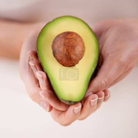 Photo for Hands, avocado and vegetable diet for nutrition, health and minerals or vitamins for wellness. Closeup, person and holding vegan food for green detox, superfoods and omega 3 for organic skincare. - Royalty Free Image