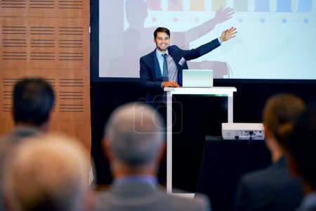Photo for Business man, podium and presentation, pointing at projector screen at conference or workshop with laptop for PPT. Corporate training, seminar and speaker with info, audience and professional speech. - Royalty Free Image