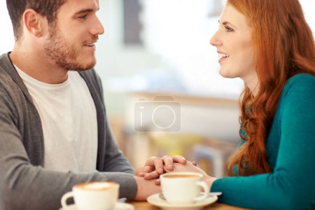 Photo for Couple, bonding and touch of hands in cafe, support and happiness for peace in relationship. Adult, woman and girl with man or partner with hand in coffee shop, smile and joy for marriage with guy. - Royalty Free Image