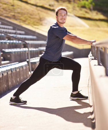 Photo for Fitness, legs and portrait of man stretching at stadium for race, marathon or competition training. Sports, health and male runner athlete with warm up exercise for running cardio workout on track - Royalty Free Image