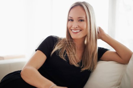 Photo for Portrait, smile and woman on a sofa relax with confidence, positive attitude or feel good mood in her home. Face, happy and female person in a living room with vacation, free time or resting holiday. - Royalty Free Image
