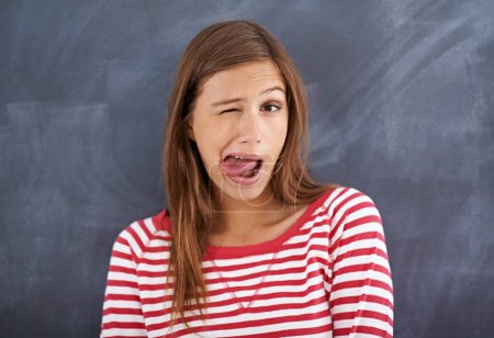 Photo for Tongue out, blackboard and portrait with woman, teacher and education with knowledge and silly. Face, funny and goofy with girl or educator with expression or emoji with reaction or quirky with humor. - Royalty Free Image