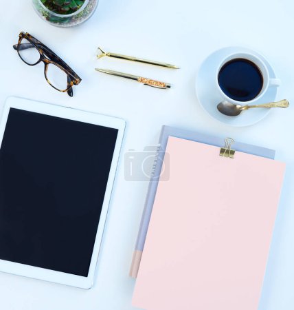 Photo for Above of notebook, tablet and coffee in studio for working, writing notes and planning for career. Creative business, mockup space and diary, smartphone or screen for social media on white background. - Royalty Free Image