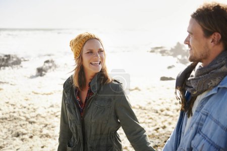 Photo for Holding hands, walking and couple by ocean in winter for bonding, romantic relationship and relax outdoors. Nature, love and happy man and woman by sea for holiday, vacation and weekend together. - Royalty Free Image