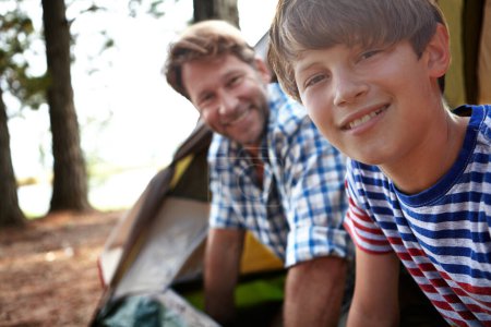 Happiness, portrait and father with boy for camping in woods for outdoor adventure in nature, tent and wilderness for bonding. Parent, kid and together in forest on campground for summer and memories.