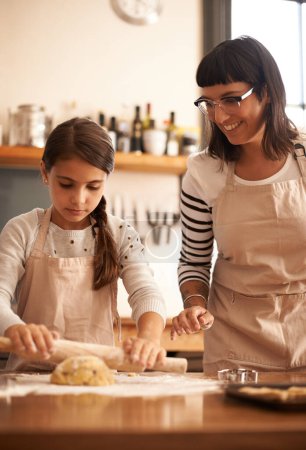 Photo for Mother, kid and happy with dough to bake biscuits in kitchen for easter season or bonding, child development and growth. Home, family and flower for cookies with fun, teaching and support for hobby. - Royalty Free Image