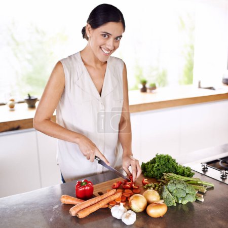 Photo for Cooking, vegetables and portrait of woman at kitchen counter with healthy food for nutrition in diet. Happy, wellness and vegan person meal prep with carrot, onion and broccoli for dinner in home. - Royalty Free Image