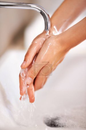 Photo for Cleaning, water and soap on hands of person with skincare, routine and grooming in home closeup. Bathroom, tap and washing skin with foam for protection of hygiene from germs, bacteria and virus. - Royalty Free Image