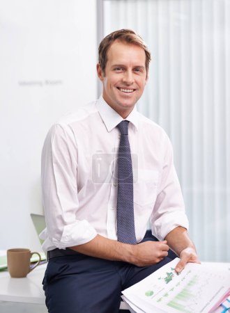 Photo for Paperwork, statistics and portrait of man in office with smile, sales review or profit report at accounting agency. Documents, business growth or development with financial advisor at desk at startup. - Royalty Free Image