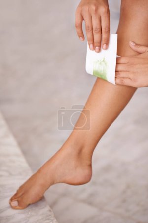 Photo for Closeup, leg and woman with waxing, skincare and wellness with dermatology and aesthetic in a bathroom. Person, lady and girl with hair removal and cosmetics with product and clear with healthy skin. - Royalty Free Image