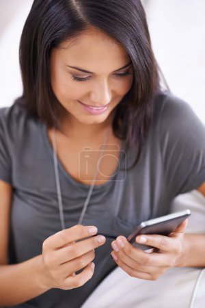 Photo for Woman, couch and phone app for social media in home, comfortable and website for entertainment. Female person, smile and internet for blog and subscription, lounge and relax on sofa for communication. - Royalty Free Image