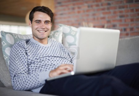 Photo for Relax, smile or portrait of man on laptop for remote work, article post website or network online. Freelancer, research or happy person on sofa typing on technology for startup, email or news in home. - Royalty Free Image