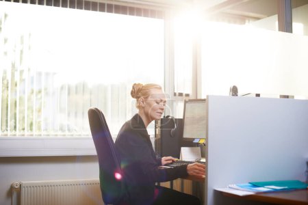 Photo for Business woman, working and planning at office desk for public relations with copywriting ideas on computer. Worker, editor or writer with desktop and paperwork for project and research in lens flare. - Royalty Free Image