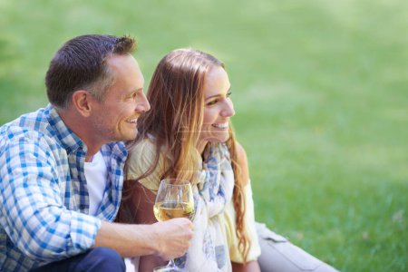Photo for Couple, travel and wine for bonding in outdoor nature, love and romance in relationship on weekend. Alcohol, conversation and people on date in countryside, adventure and relax on grass for vacation. - Royalty Free Image