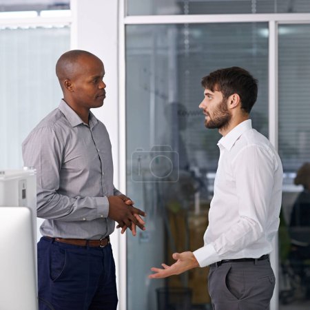 Photo for Men, discussion and conversation in hallway at office for ideas, listen or collaboration at company. Business people, teamwork and diversity with advice for questions in workplace at corporate agency. - Royalty Free Image