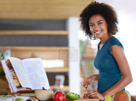 Photo for Cooking, portrait and happy woman cutting vegetables with recipe book in kitchen for healthy diet, nutrition or lunch. Chopping board, food or face of African person preparing organic meal in home. - Royalty Free Image
