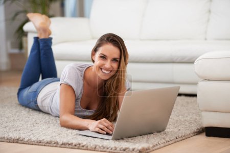 Photo for Woman, portrait and laptop on floor with internet for typing, communication and email on mat in living room of home. Person, smile or technology on ground with relax, streaming show or watching video. - Royalty Free Image