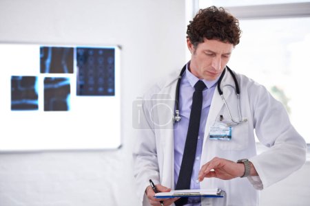 Photo for Doctor, man and check time in hospital with clipboard for neurology with thinking, schedule or planning. Medic, checklist and watch or wristwatch with document, idea or review for healthcare results. - Royalty Free Image