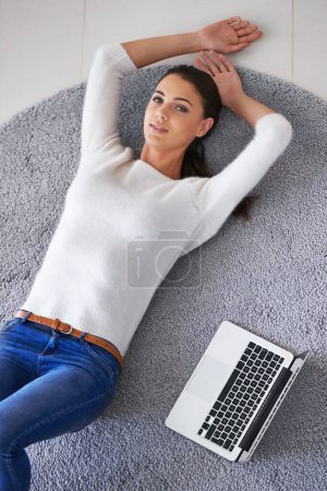 Photo for Happy woman, portrait and lying with laptop on floor for break, rest or research at home. Top view of female person or freelancer with smile, computer and relax on rug or mat for networking at house. - Royalty Free Image