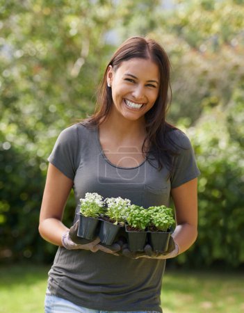 Photo for Happy woman, flowers and gardening with portrait in nature, ecology and sustainability with environment. Landscaping, gardener with plant and eco friendly for growth, greenery and botanical outdoor. - Royalty Free Image