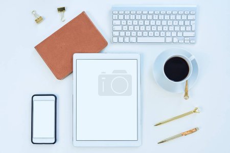 Photo for Tablet, phone and mockup screen above for social media, tech and business for content creation work. Desk, creative space and workspace with startup technology and coffee in a seo optimization office. - Royalty Free Image