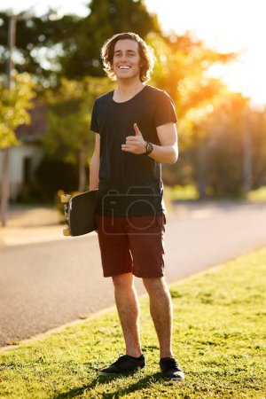 Photo for Smile, portrait and skateboarder with shaka hand gesture outdoor for hobby, skill practice and cruising. Male person, happy and hang loose in summer break for urban fun, freedom and extreme sports. - Royalty Free Image