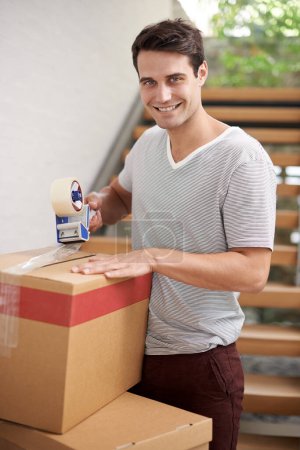 Photo for Man, portrait and boxes in home for moving with investment in real estate, new house pr relax with happiness. Person, face or smile with tape on cardboard for storage, cargo or package for relocating. - Royalty Free Image