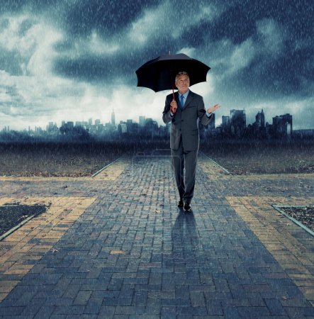 Photo for Businessman, umbrella and walking for security in rain, insurance at crossroads by city background for choice. Mature person, winter and street with dark clouds in storm and future decision for path. - Royalty Free Image