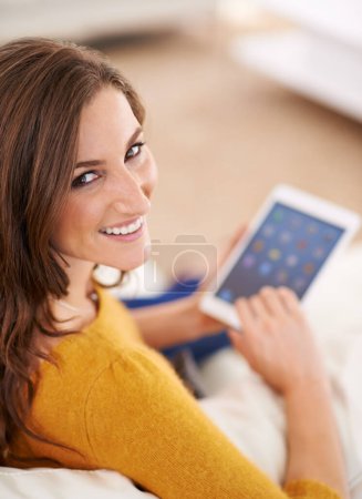 Photo for Happy, woman and portrait with tablet on sofa reading ebook on app to relax on holiday or vacation in home. Girl, smile and lounge on tech with blog, article or news from search on internet in house. - Royalty Free Image