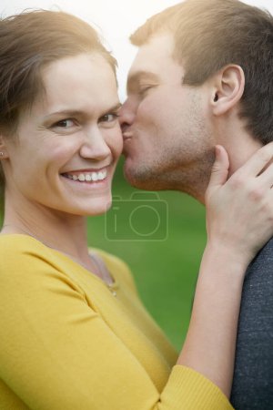 Photo for Love, kiss and portrait of couple in nature for outdoor countryside vacation, getaway or holiday together. Romance, smile and young man and woman on date for bonding on weekend trip in Australia - Royalty Free Image