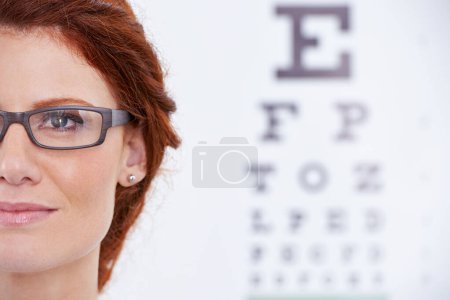 Woman, glasses and eye chart or vision consultation or prescription lens for eyewear health, examination or checkup. Female person, frame and optical test or wellness or letters, diagnosis or reading.