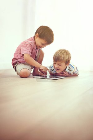Photo for Kids, tablet and happy siblings on floor for funny cartoon, gaming or movie at home. Digital, learning and boy children in house for google it, search or ebook storytelling, app or Netflix and chill. - Royalty Free Image