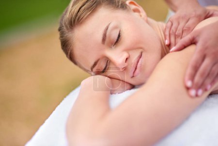 Photo for Massage, woman and spa for therapy, wellness and relaxation in muscles, back and neck for self care. Female person, physical health and detox for body with smile, calm and happiness on holiday. - Royalty Free Image