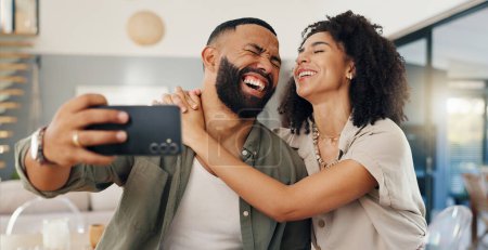Photo for Home, selfie and couple with love, funny and smile with happiness and social media in a living room. Apartment, man and woman in a lounge, profile picture and humor with laughing and bonding together. - Royalty Free Image