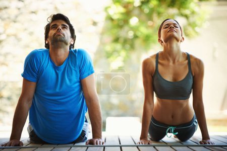 Photo for Man, woman and yoga class for meditation, fitness and wellness for health and workout. People, sitting and zen for peace, cobra pose and balance with instructor for holistic energy with home pilates. - Royalty Free Image