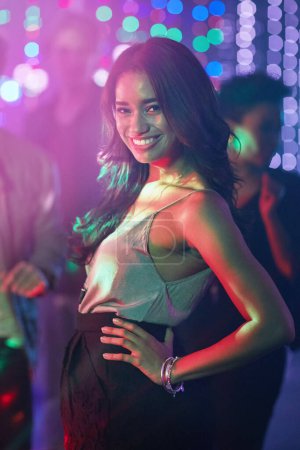 Woman, portrait and confident in nightclub for new years eve, birthday and party or disco in Mexico. Smile, dancer and fashion in festival for concert, dancing and celebration on dance floor in city.