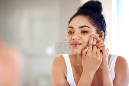 Photo for Skincare, reflection and woman popping acne on face with hands, dirt or scar on skin in home. Dermatology, facial wellness and girl in bathroom to squeeze pimple, checking mirror or morning routine. - Royalty Free Image