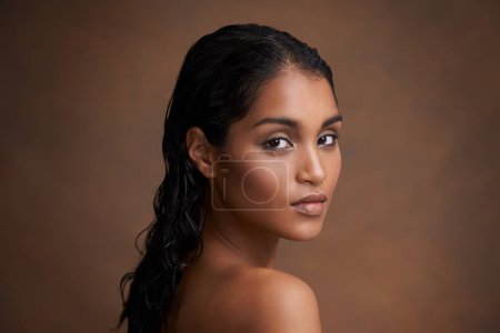 Photo for Hair, wet or portrait of Indian woman in studio for beauty, wellness or shine cosmetics on brown background. Haircare, cleaning or calm lady model face with shampoo, results or scalp detox treatment. - Royalty Free Image