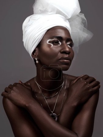 Photo for Thinking, wrap and black woman with makeup, beauty and confidence on dark studio background. Face, turban and African model with traditional outfit, eyeshadow cosmetics and necklace for culture pride. - Royalty Free Image