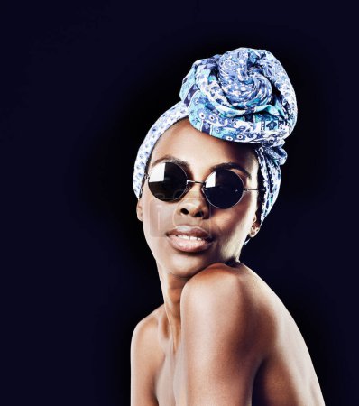 Photo for Portrait, beauty and fashion with African woman in studio isolated on black background for heritage. Culture, model and sunglasses with confident young person in trendy headwear for traditional style. - Royalty Free Image