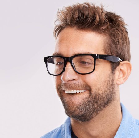 Photo for Silly face, nerd and man with glasses, happiness and facial expression on a grey studio background. Model, eyewear and person with goofy guy and reaction with character and quirky with comedy or joke. - Royalty Free Image
