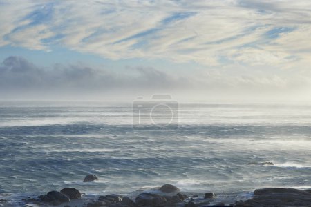 Photo for Clouds, sky and sea with rocks in nature for vacation, holiday or weekend trip in summer. Stones, water and ocean waves by tropical island for travel in Cape town for outdoor paradise scenery - Royalty Free Image