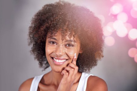 Photo for African woman, portrait and skin cream with smile, wellness and afro in home bathroom to start morning routine. Girl, person and serum with cosmetics, bokeh or transformation with beauty in apartment. - Royalty Free Image