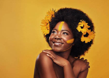 Photo for Woman, studio and thinking with hands and sunflowers for idea, planning or vision with afro. African female and thought on mustard backdrop with makeup, natural beauty or skincare with sustainability. - Royalty Free Image