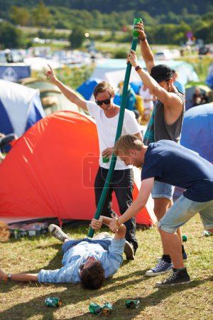 Photo for Beer, music festival or drunk friends drinking together on vacation or outdoor social event in summer. Concert, crazy party games celebration or excited people with hose funnel or alcohol pipe tube. - Royalty Free Image