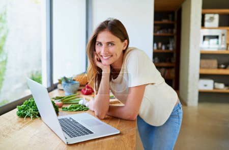 Photo for Cooking, home and woman with food, laptop and vegetable lunch for online search. Diet, wellness and girl at kitchen counter with website for recipe research, ingredients and nutrition for gut health. - Royalty Free Image